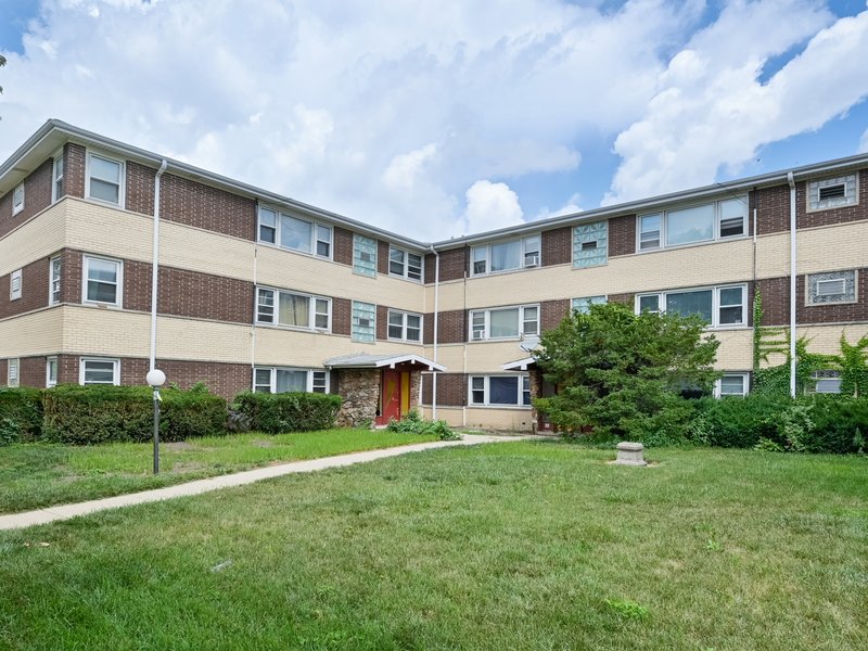 Courtyard apartment building with a landscaped garden